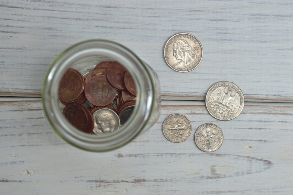 coins in a jar stock image for raise your freelance rates blog post