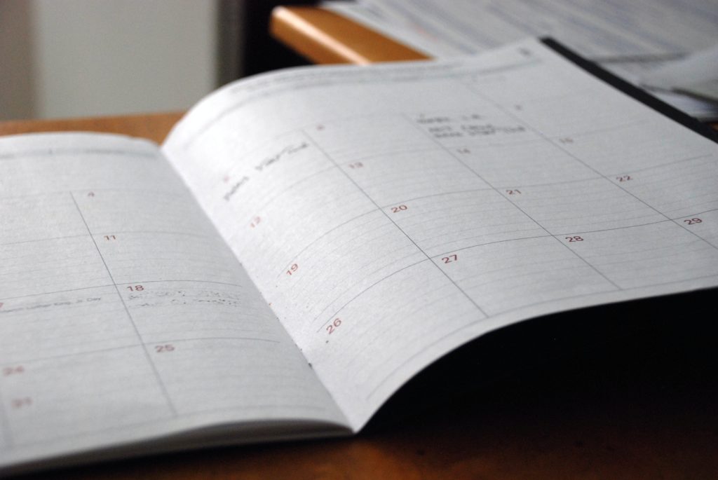 Stock image of a page of an open notebook-style calendar.